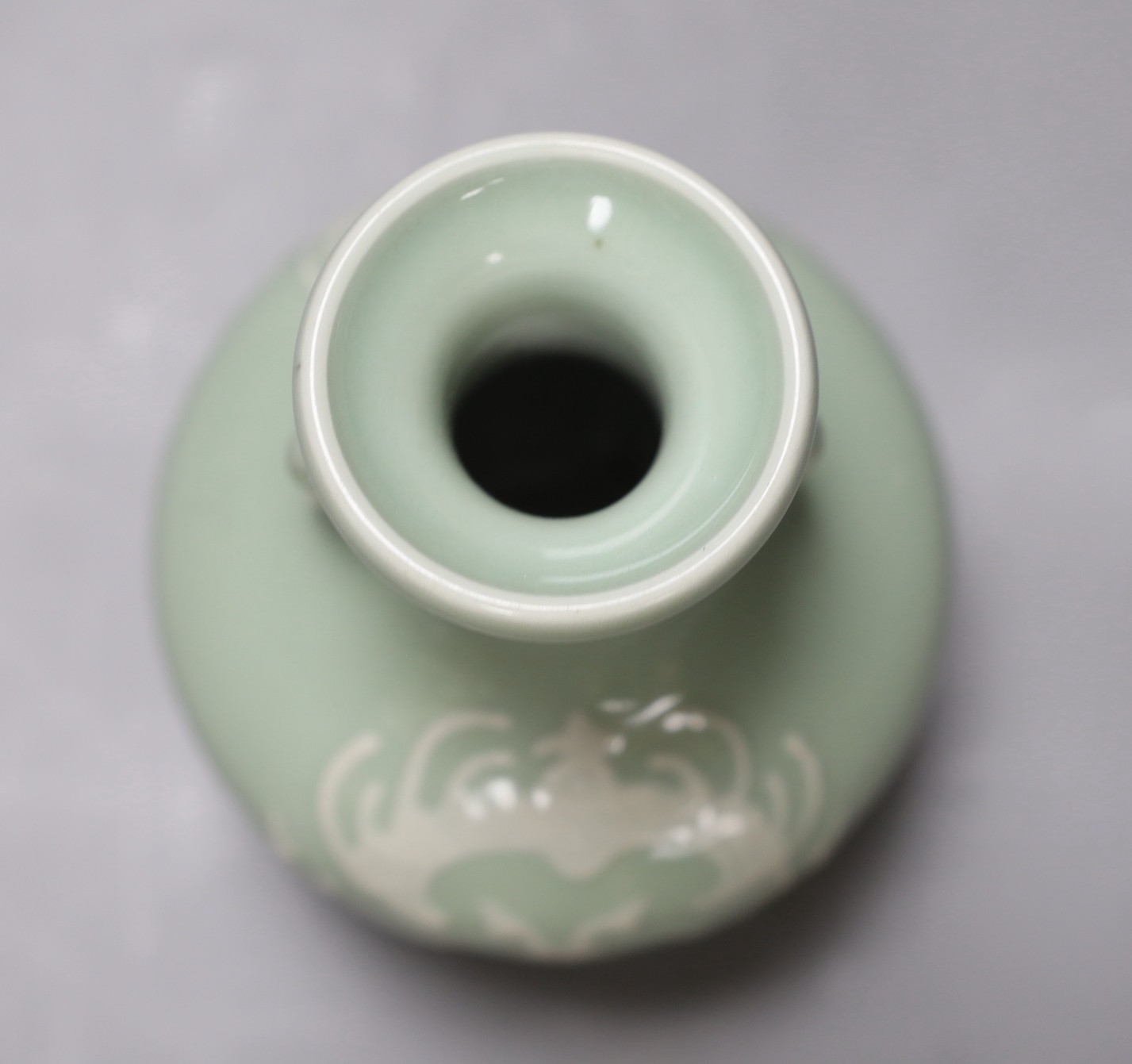 A Chinese celadon two handled vase with slip decoration, 15cm tall